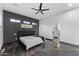 Modern primary bedroom with a sleek design, dark accent wall, and ensuite bathroom access at 1211 E Hayward Ave, Phoenix, AZ 85020