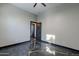 Bedroom featuring unique stained concrete flooring, ceiling fan, and modern gray walls at 1211 E Hayward Ave, Phoenix, AZ 85020