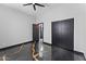 Modern bedroom with dark marble-look floors and stylish barn doors leading to the closet and bathroom at 1211 E Hayward Ave, Phoenix, AZ 85020
