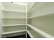 Walk in closet with white shelving at 1211 E Hayward Ave, Phoenix, AZ 85020