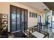 Open dining area featuring modern glass table, artwork, and custom lighting next to the kitchen at 1211 E Hayward Ave, Phoenix, AZ 85020