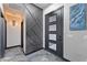Modern entryway featuring a decorative accent wall, sleek door with windows, and marbled floors at 1211 E Hayward Ave, Phoenix, AZ 85020