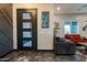 Contemporary front door entry with three glass panes and view to living room at 1211 E Hayward Ave, Phoenix, AZ 85020
