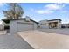 Contemporary home with gray exterior, concrete driveway, garage, and gravel landscaping at 1211 E Hayward Ave, Phoenix, AZ 85020