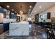 Open kitchen with large marble island, custom cabinetry, and stainless steel appliances flowing into a living space at 1211 E Hayward Ave, Phoenix, AZ 85020