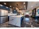 Spacious kitchen featuring a waterfall island, stainless steel appliances, blue cabinets, and stylish pendant lights at 1211 E Hayward Ave, Phoenix, AZ 85020