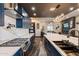 Close-up of kitchen featuring custom cabinets, marble backsplash, and modern stainless steel gas range and vent hood at 1211 E Hayward Ave, Phoenix, AZ 85020