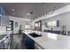 Open-concept kitchen with a large island, stainless steel appliances, and modern lighting fixtures at 1211 E Hayward Ave, Phoenix, AZ 85020