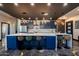 Beautiful kitchen with large center island, seating, custom lighting and bold blue cabinets at 1211 E Hayward Ave, Phoenix, AZ 85020