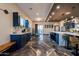 Open kitchen showcasing a large island with bar seating, modern appliances, and statement lighting at 1211 E Hayward Ave, Phoenix, AZ 85020