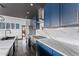 Stylish kitchen featuring custom blue cabinetry, modern appliances, and quartz countertops with backsplash at 1211 E Hayward Ave, Phoenix, AZ 85020