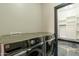 Laundry room featuring modern appliances and a door that leads to a walk-in closet at 1211 E Hayward Ave, Phoenix, AZ 85020