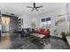 Bright living room featuring stylish sofas, unique flooring, and an elegant ceiling fan at 1211 E Hayward Ave, Phoenix, AZ 85020