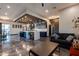 Open-concept living room and kitchen with modern finishes, statement lighting, and sleek flooring at 1211 E Hayward Ave, Phoenix, AZ 85020
