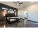 Main bedroom with ceiling fan, accent wall, modern lighting and en suite bathroom at 1211 E Hayward Ave, Phoenix, AZ 85020
