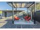 Outdoor patio with metal pergola, concrete base, seating, and fresh gravel at 1211 E Hayward Ave, Phoenix, AZ 85020