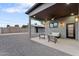 Covered patio with modern seating, ceiling fan, and stylish outdoor lighting fixtures at 1211 E Hayward Ave, Phoenix, AZ 85020