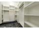 Spacious walk-in closet featuring custom white shelving with black metal hanging rods at 1211 E Hayward Ave, Phoenix, AZ 85020