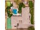 Overhead view highlighting the backyard with a pool, sports court, putting green, and patio with seating at 13206 N 64Th St, Scottsdale, AZ 85254