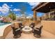 Cozy backyard fire pit with seating, near a pool, a waterfall feature, and a spa at 13206 N 64Th St, Scottsdale, AZ 85254