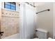 Bathroom with a shower featuring decorative tiles and a matching patterned shower curtain at 13206 N 64Th St, Scottsdale, AZ 85254
