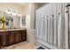Bathroom with a shower featuring decorative tiles and a granite countertop vanity with dark wood cabinetry at 13206 N 64Th St, Scottsdale, AZ 85254