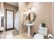 Bathroom featuring a pedestal sink, decorative mirror, and a walk-in shower at 13206 N 64Th St, Scottsdale, AZ 85254