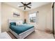 Comfortable bedroom featuring a ceiling fan, soft carpet, and a cozy bed with stylish pillows at 13206 N 64Th St, Scottsdale, AZ 85254
