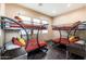 Bedroom with two bunk beds with red covers and a dark hardwood floor at 13206 N 64Th St, Scottsdale, AZ 85254