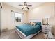 Comfortable bedroom featuring a ceiling fan, soft carpet, and a cozy bed with stylish pillows at 13206 N 64Th St, Scottsdale, AZ 85254