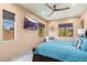 Bright bedroom showcasing multiple windows, mounted TV, and plush bedding for a cozy retreat at 13206 N 64Th St, Scottsdale, AZ 85254