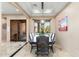 Bright dining room featuring stylish light fixture, tile floors, and an attractive desert scene painting at 13206 N 64Th St, Scottsdale, AZ 85254