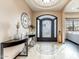 Elegant foyer features a decorative iron door, accent furniture, and decorative tiling at 13206 N 64Th St, Scottsdale, AZ 85254