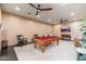 Spacious game room featuring a pool table, comfortable seating, and ceiling fans at 13206 N 64Th St, Scottsdale, AZ 85254