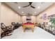 Recreational game room featuring a pool table, comfortable seating, and a ceiling fan for air circulation at 13206 N 64Th St, Scottsdale, AZ 85254