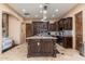 Spacious kitchen featuring a center island with a granite countertop and dark wood cabinetry at 13206 N 64Th St, Scottsdale, AZ 85254