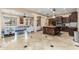 Open concept gourmet kitchen with dark wood cabinets, tile floors, and stainless steel appliances at 13206 N 64Th St, Scottsdale, AZ 85254