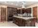 Gourmet kitchen featuring a large island with granite countertops, stainless steel appliances and dark wood cabinetry at 13206 N 64Th St, Scottsdale, AZ 85254