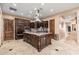 Gourmet kitchen boasts a center island, dark wood cabinetry, and stainless steel appliances at 13206 N 64Th St, Scottsdale, AZ 85254