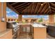Beautiful outdoor kitchen with stainless steel grill, granite countertops, and ample space for entertaining at 13206 N 64Th St, Scottsdale, AZ 85254