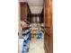 Walk-in pantry with dark wood cabinets and shelving filled with an array of food and beverage items at 13206 N 64Th St, Scottsdale, AZ 85254