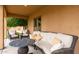 Inviting covered patio with comfortable seating and views of a lush orange tree at 13206 N 64Th St, Scottsdale, AZ 85254