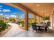 Outdoor patio with a dining table that overlooks a pool and backyard at 13206 N 64Th St, Scottsdale, AZ 85254
