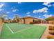 Private sport court with basketball hoop and tennis net, providing recreational fun in a well-maintained backyard at 13206 N 64Th St, Scottsdale, AZ 85254
