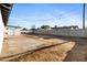 Large and flat backyard featuring dirt, mature plants, and block fencing at 13624 N 31St Ave, Phoenix, AZ 85029