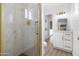 The remodeled bathroom features a tiled shower with glass door, a white vanity, and new light fixture at 13624 N 31St Ave, Phoenix, AZ 85029