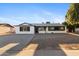 Charming single-story home featuring a fresh white exterior, contrasting black trim, and large front yard at 13624 N 31St Ave, Phoenix, AZ 85029