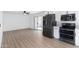 Bright kitchen with stainless steel appliances and light wood vinyl flooring, with access to outdoor patio at 13624 N 31St Ave, Phoenix, AZ 85029