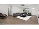 Bright living room features modern sofas, hardwood floors, and a ceiling fan at 13624 N 31St Ave, Phoenix, AZ 85029