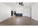 Bright, open-concept living space with wood floors, a modern ceiling fan, and a seamless flow to the kitchen at 13624 N 31St Ave, Phoenix, AZ 85029